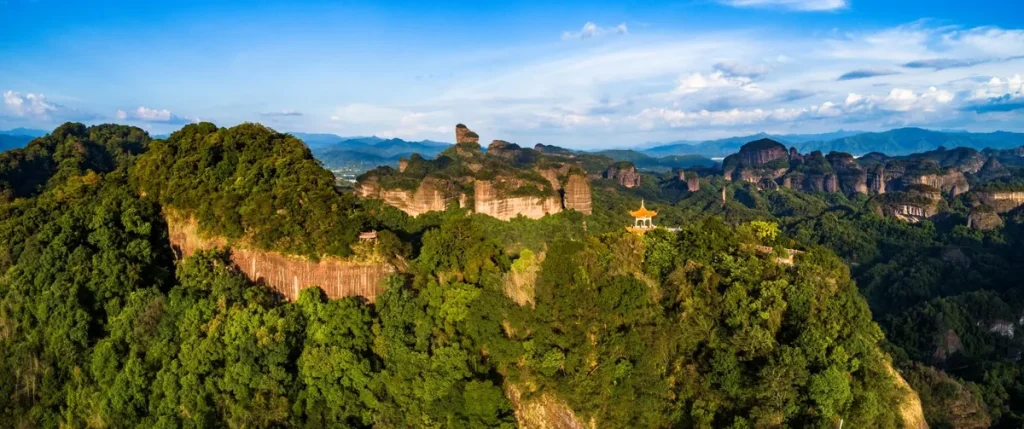 The iconic Monk's Hat Peak (Sengmao Feng) of Danxia Mountain, shaped like a Buddhist monk's hat against the sky