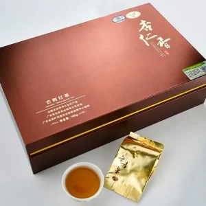 Xuehuayan Ancient Trees Black Tea Legend — packaging with gold foil packet and brewed tea cup