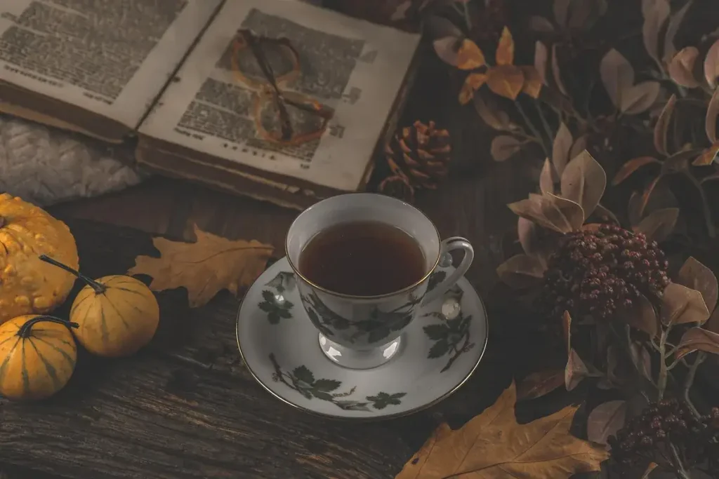 Ceramic teacup with brewed tea on rustic wooden table — tea ceremony aesthetic